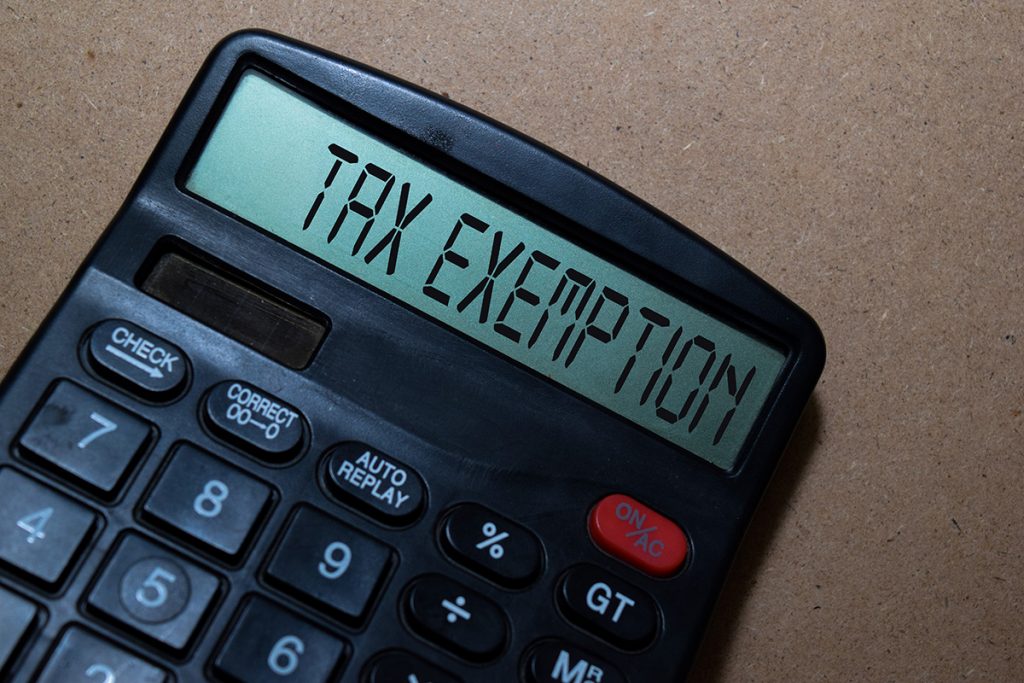 Calculator displaying "tax exemption," representing the financial impact of a church 501(c)(3) application