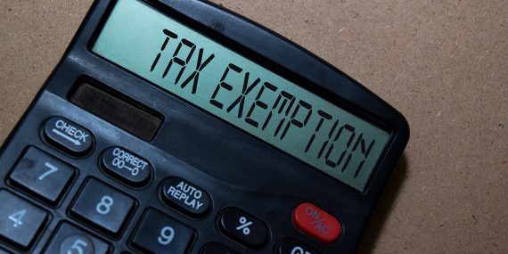 Calculator displaying "tax exemption," representing the financial impact of a church 501(c)(3) application