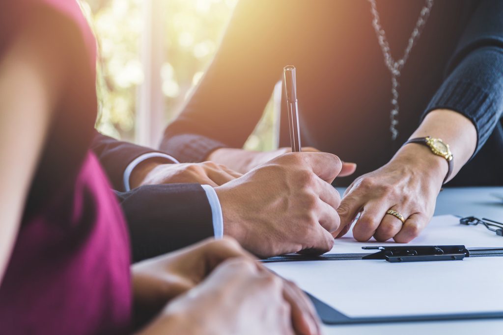 Fund your trust: a couple signing estate planning documents together