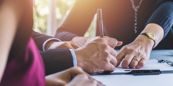 Fund your trust: a couple signing estate planning documents together