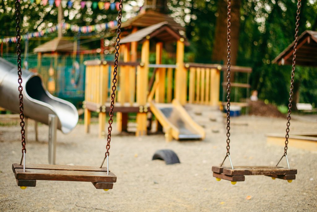A preschool playground with swings, illustrating how transitional kindergarten and church preschools serve California's four-year-olds
