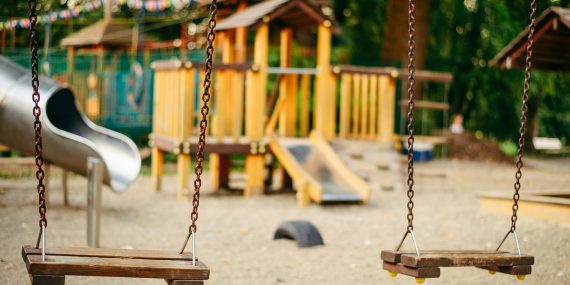 A preschool playground with swings, illustrating how transitional kindergarten and church preschools serve California's four-year-olds