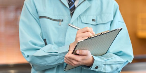 Church staff member reviewing and signing a written active shooter and security team policy on a clipboard